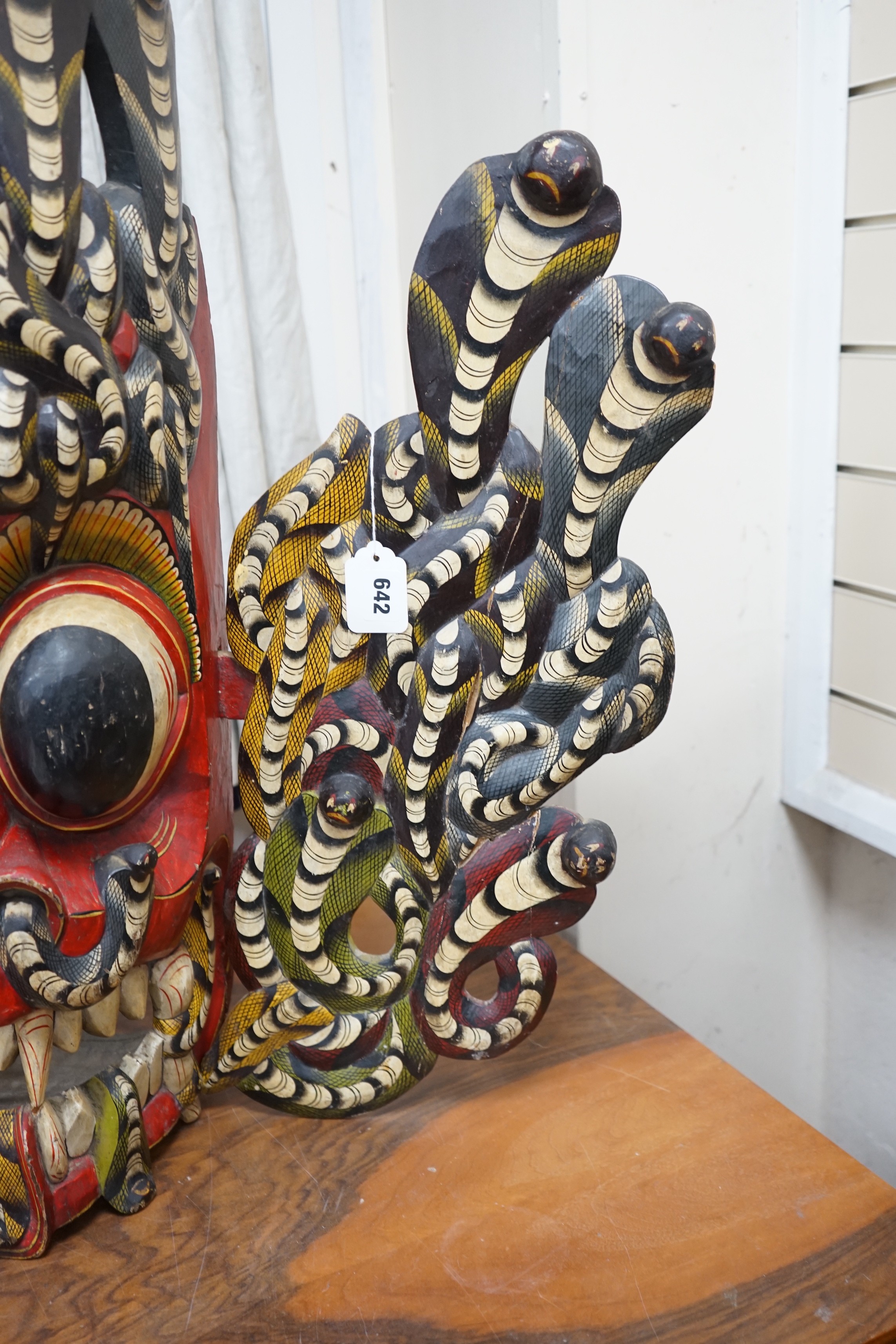 A large interesting Sri-Lankan painted wood Naga Raksha mask, early 20th century, 77cm tall